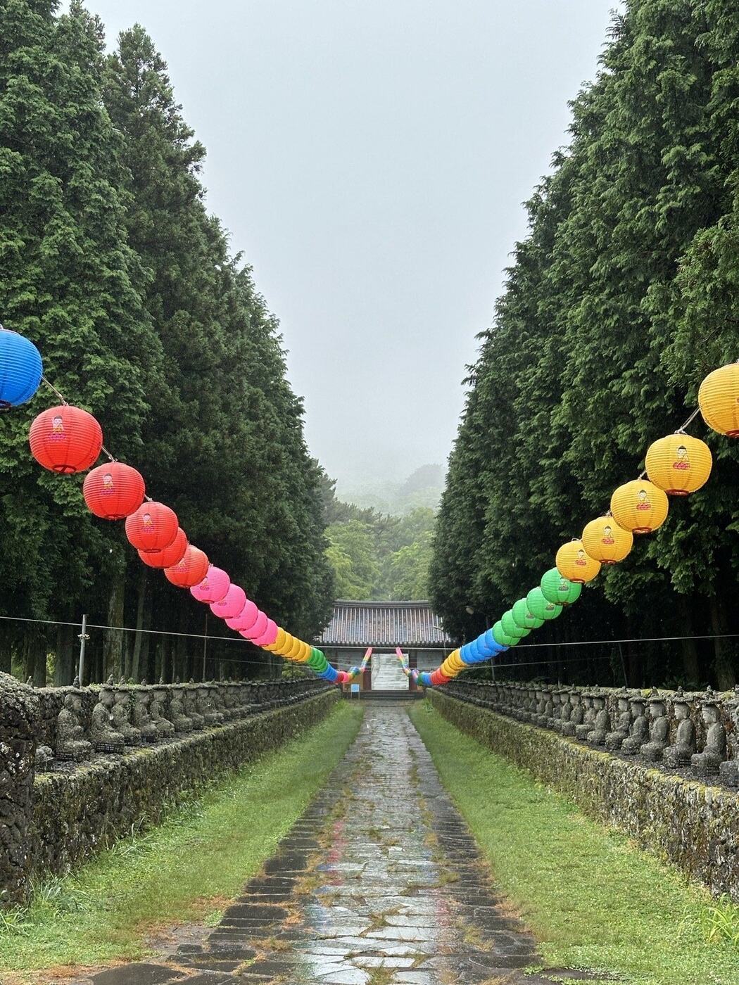 Stone temple path decorated with colourful lanterns