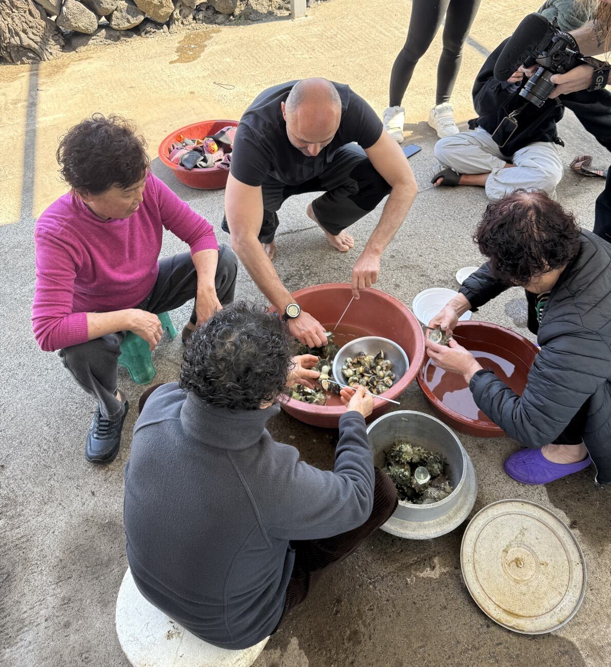 Guests sitting with Jeju haenyeo in their village